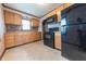 Functional kitchen with light wood cabinetry, black appliances, and neutral countertops at 2249 Maple St, Columbus, IN 47201
