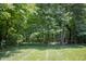 Secluded backyard featuring lush greenery, mature trees, and a well-maintained lawn offering a tranquil outdoor space at 23119 Sonoma Ln, Cicero, IN 46034