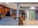 Basement bar area featuring wooden cabinets, stainless steel refrigerator, and bar stool seating at 23119 Sonoma Ln, Cicero, IN 46034