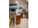 Open concept bar area features granite countertops, wooden cabinetry and stainless steel appliances at 23119 Sonoma Ln, Cicero, IN 46034