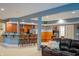 Finished basement showcasing bar with seating, arcade game, and comfortable leather sofa at 23119 Sonoma Ln, Cicero, IN 46034