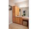 Bright bathroom with vanity, mirror, sconces, ottoman, and tile floors at 23119 Sonoma Ln, Cicero, IN 46034