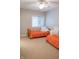Comfortable bedroom with two twin beds featuring bright orange bedspreads and a sunlit window at 23119 Sonoma Ln, Cicero, IN 46034