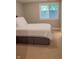 Bedroom with a plush white bed, soft carpet, and a sunlit window that creates a peaceful atmosphere at 23119 Sonoma Ln, Cicero, IN 46034