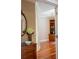 Attractive entryway showcasing decorative cabinet, dark marble countertop, round mirror, and hardwood floors at 23119 Sonoma Ln, Cicero, IN 46034