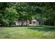 Spacious front yard with a beautiful brick home nestled among mature trees at 23119 Sonoma Ln, Cicero, IN 46034