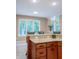 Kitchen with granite countertops, wood cabinets, and a view of the backyard through the windows at 23119 Sonoma Ln, Cicero, IN 46034