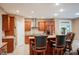 Kitchen with granite countertops, a stainless vent hood, and a breakfast bar with seating at 23119 Sonoma Ln, Cicero, IN 46034