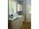 White washer and dryer in laundry room with a window and white cabinets at 23119 Sonoma Ln, Cicero, IN 46034