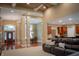 Open-concept living room with a dark leather sofa, beautiful hardwood floors, and coffered ceilings at 23119 Sonoma Ln, Cicero, IN 46034