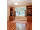 Cozy living room with built-in bookshelves and a large window offering plenty of natural light at 23119 Sonoma Ln, Cicero, IN 46034