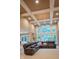 Bright living room boasting a coffered ceiling, large windows, and a comfortable leather sectional at 23119 Sonoma Ln, Cicero, IN 46034