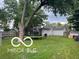 The large backyard has a trampoline, shade tree, and plenty of lawn space at 2412 Mars Hill St, Indianapolis, IN 46241