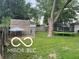 Backyard has a trampoline and dog kennel on a large lot at 2412 Mars Hill St, Indianapolis, IN 46241