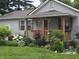 Charming home featuring a cozy covered porch, beautiful landscaping, and welcoming curb appeal at 2412 Mars Hill St, Indianapolis, IN 46241