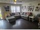 Bright living room featuring hardwood floors, neutral color scheme, and cozy sectional couch at 2412 Mars Hill St, Indianapolis, IN 46241
