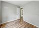 Bedroom featuring wood floors, neutral gray walls, and doorway at 2524 E 17Th St, Indianapolis, IN 46218