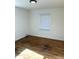 Bright bedroom featuring gleaming hardwood floors and a window to allow for natural light at 2631 Mcleay Dr, Indianapolis, IN 46220