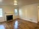Spacious living room features gleaming hardwood floors and a fireplace at 2631 Mcleay Dr, Indianapolis, IN 46220