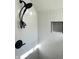 Modern shower featuring sleek subway tile, a black shower head, and a built-in niche at 2631 Mcleay Dr, Indianapolis, IN 46220