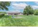 Spacious backyard with a firepit, mature trees, and well-manicured lawn, perfect for outdoor activities at 2875 E Woodside Dr, Mooresville, IN 46158