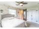 Charming bedroom with wood accent wall, light neutral colors, and decorative sliding barn door to ensuite at 2875 E Woodside Dr, Mooresville, IN 46158