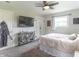 Relaxing bedroom with mounted television, natural light, and decorative sliding barn doors at 2875 E Woodside Dr, Mooresville, IN 46158