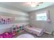 Cozy bedroom with whimsical decor, a single window, and a striped accent wall at 2875 E Woodside Dr, Mooresville, IN 46158