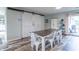 Bright dining room features wood floors, sliding barn doors, and a sliding glass door to the backyard at 2875 E Woodside Dr, Mooresville, IN 46158