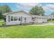 Charming single-story home with gray brick, a two-car garage, and well-maintained landscaping at 2875 E Woodside Dr, Mooresville, IN 46158