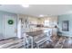 Bright kitchen featuring white cabinets, laminate floors, and a spacious dining area perfect for Gathering meals at 2875 E Woodside Dr, Mooresville, IN 46158