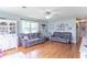 Cozy living room featuring hardwood floors, two sofas, and plenty of natural light at 2875 E Woodside Dr, Mooresville, IN 46158