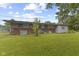 Backyard view of the home with a brick foundation and large grassy lawn at 31 Brooklyn Ct, Mooresville, IN 46158