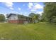 A view of the home's backyard with a brick foundation and a large grassy lawn at 31 Brooklyn Ct, Mooresville, IN 46158