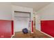 Bedroom with half red and half white painted walls, closet, and an exit door at 31 Brooklyn Ct, Mooresville, IN 46158