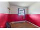 Bedroom with half red and half white painted walls, window, and hardwood floors at 31 Brooklyn Ct, Mooresville, IN 46158