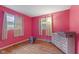 Pink bedroom featuring a window, hardwood floors, dresser, and a television at 31 Brooklyn Ct, Mooresville, IN 46158