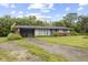 Cozy single-story home featuring a brick base, light blue siding, carport, and a spacious front yard at 31 Brooklyn Ct, Mooresville, IN 46158