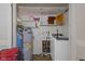 Compact laundry room with washer, water heater, shelves, storage, and utility features at 31 Brooklyn Ct, Mooresville, IN 46158