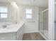 Modern bathroom featuring double sinks, a quartz countertop, and a glass-enclosed shower at 3307 Noriker Ln, Zionsville, IN 46077
