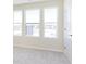 Bright bedroom featuring neutral carpet and three large windows for ample natural light at 3307 Noriker Ln, Zionsville, IN 46077