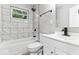 Updated bathroom with marble-style tiled shower, black fixtures, and modern vanity at 360 Richie Ave, Indianapolis, IN 46234