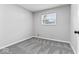 Neutral bedroom featuring soft gray carpet and a window providing bright natural light at 360 Richie Ave, Indianapolis, IN 46234