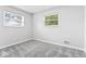 Bright bedroom with neutral carpet and two windows providing natural light at 360 Richie Ave, Indianapolis, IN 46234