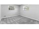 Comfortable bedroom with plush gray carpeting and bright natural light from two windows at 360 Richie Ave, Indianapolis, IN 46234