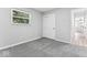 Neutral bedroom featuring soft gray carpet, a window, and a closet with double doors at 360 Richie Ave, Indianapolis, IN 46234