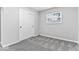 Bedroom with neutral carpet, a window and a closet featuring sliding doors at 360 Richie Ave, Indianapolis, IN 46234