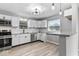 Modern kitchen with granite counters, stainless steel appliances, and stylish white cabinets at 360 Richie Ave, Indianapolis, IN 46234