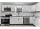 Stylish kitchen featuring stainless steel appliances, granite counters, and ample cabinet space at 360 Richie Ave, Indianapolis, IN 46234