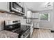 Modern kitchen with stainless steel appliances, granite countertops, and white subway tile backsplash at 360 Richie Ave, Indianapolis, IN 46234